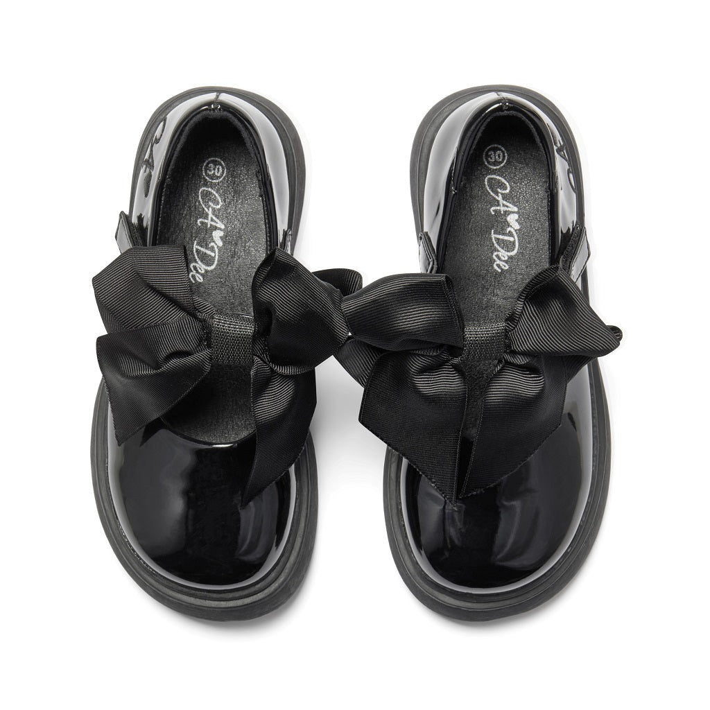 ADEE The Lyra shoe is perfect for school, with pretty bows on the velcro strap and embroidered logo to the side. Finished with non-slip rubber soles. Black