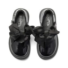 ADEE The Lyra shoe is perfect for school, with pretty bows on the velcro strap and embroidered logo to the side. Finished with non-slip rubber soles. Black