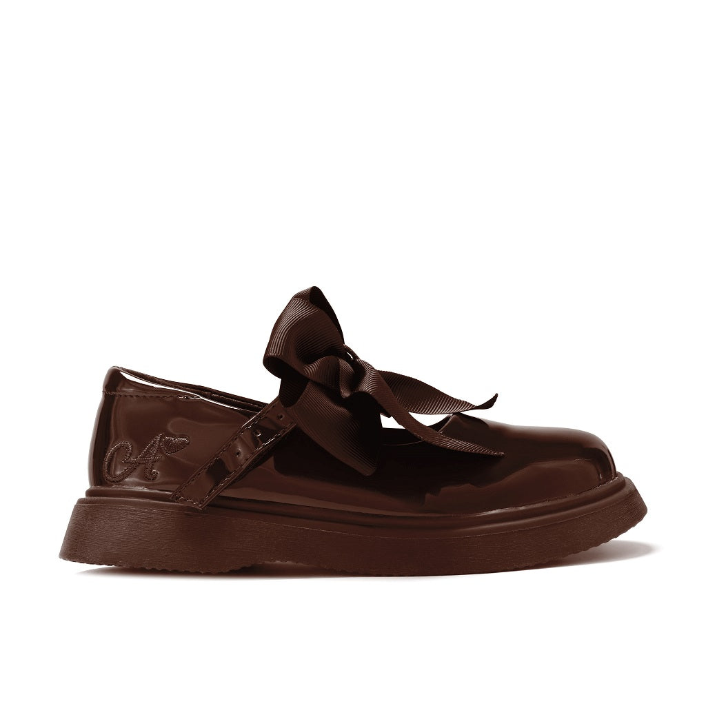 ADEE The Lyra shoe is perfect for school, with pretty bows on the velcro strap and embroidered logo to the side. Finished with non-slip rubber soles. Brown.