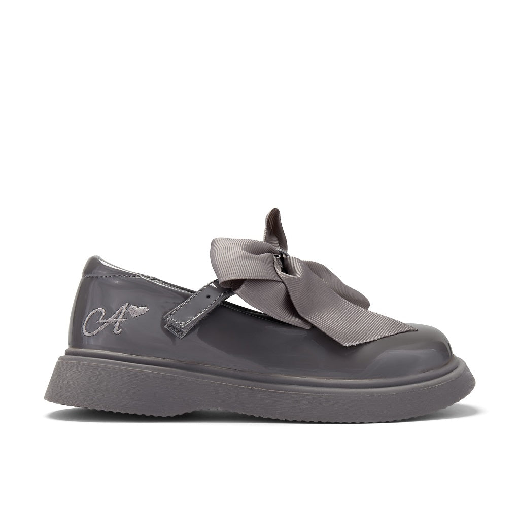 ADEE The Lyra shoe is perfect for school, with pretty bows on the velcro strap and embroidered logo to the side. Finished with non-slip rubber soles. Dark Grey