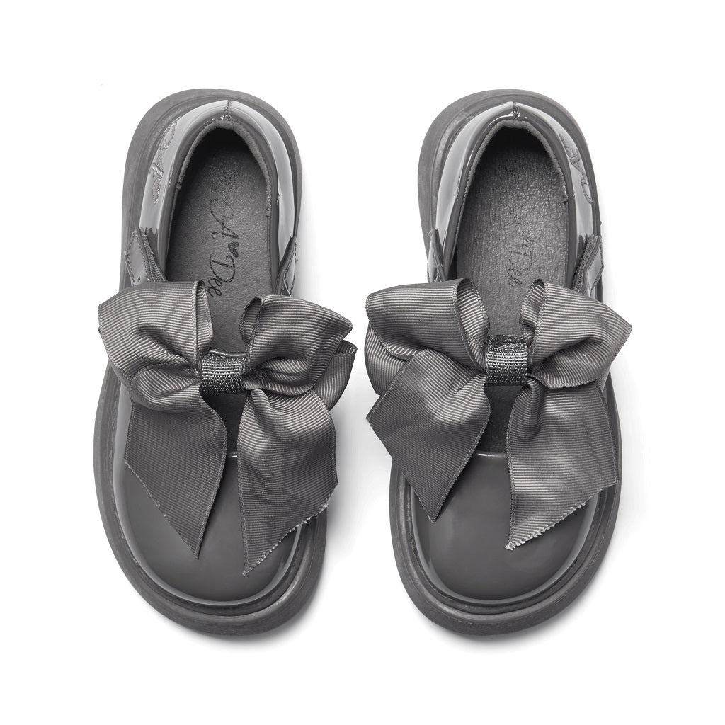 ADEE The Lyra shoe is perfect for school, with pretty bows on the velcro strap and embroidered logo to the side. Finished with non-slip rubber soles. Dark Grey