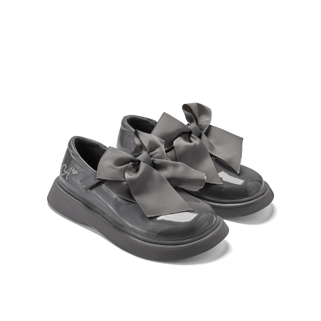 ADEE The Lyra shoe is perfect for school, with pretty bows on the velcro strap and embroidered logo to the side. Finished with non-slip rubber soles. Dark Grey
