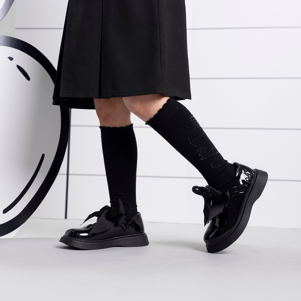 ADEE The Lyra shoe is perfect for school, with pretty bows on the velcro strap and embroidered logo to the side. Finished with non-slip rubber soles. Black