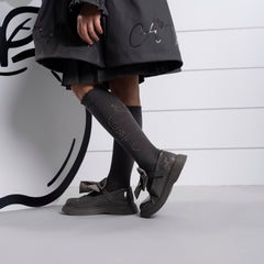 ADEE The Lyra shoe is perfect for school, with pretty bows on the velcro strap and embroidered logo to the side. Finished with non-slip rubber soles. Dark Grey