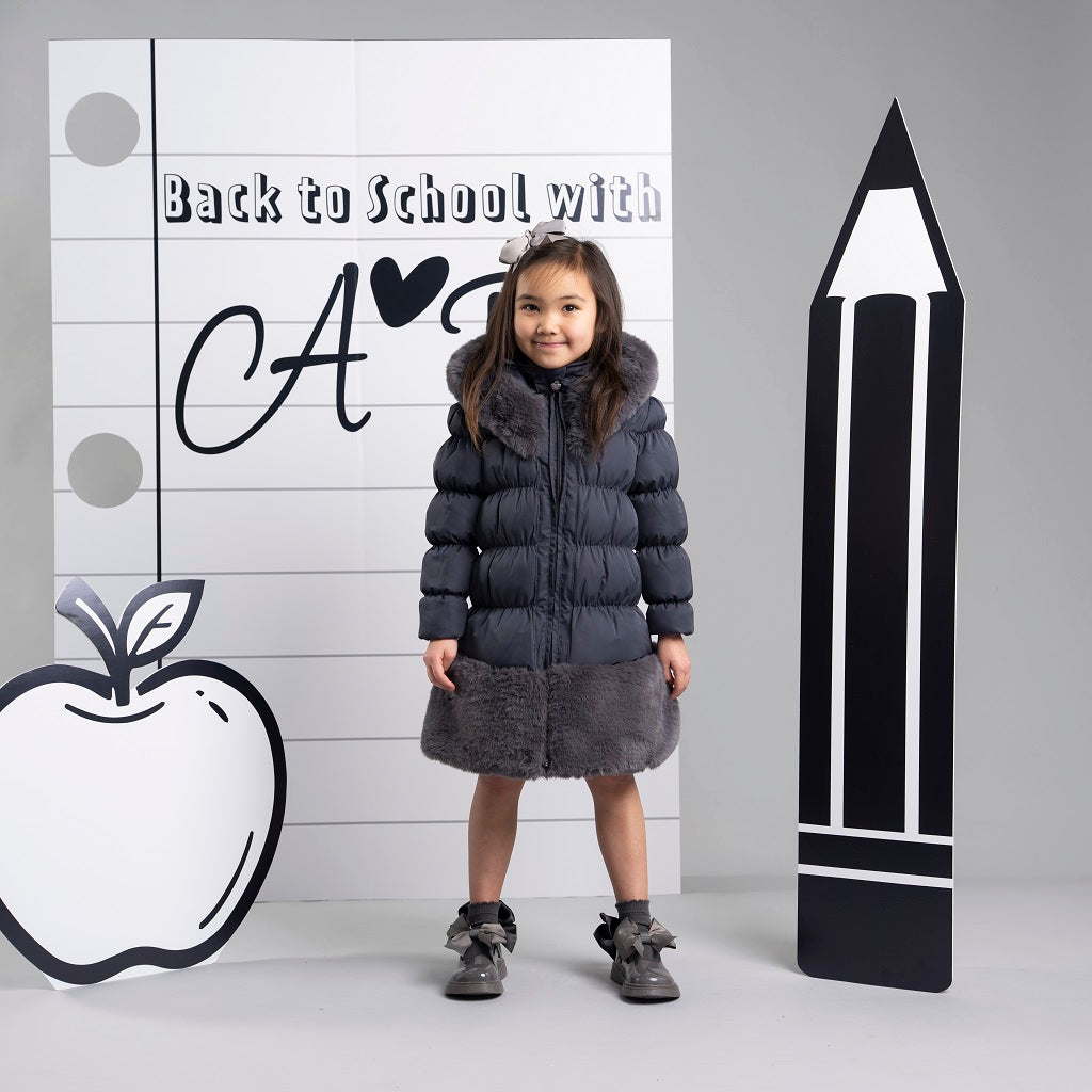 ADEE BTS The Rhea long length padded jacket features a luxurious fur trim around the hem and on the hood. Complete with a diamante badge on one sleeve and branded zip fastening. The perfect jacket to keep cosy going back to school. Dark Grey
