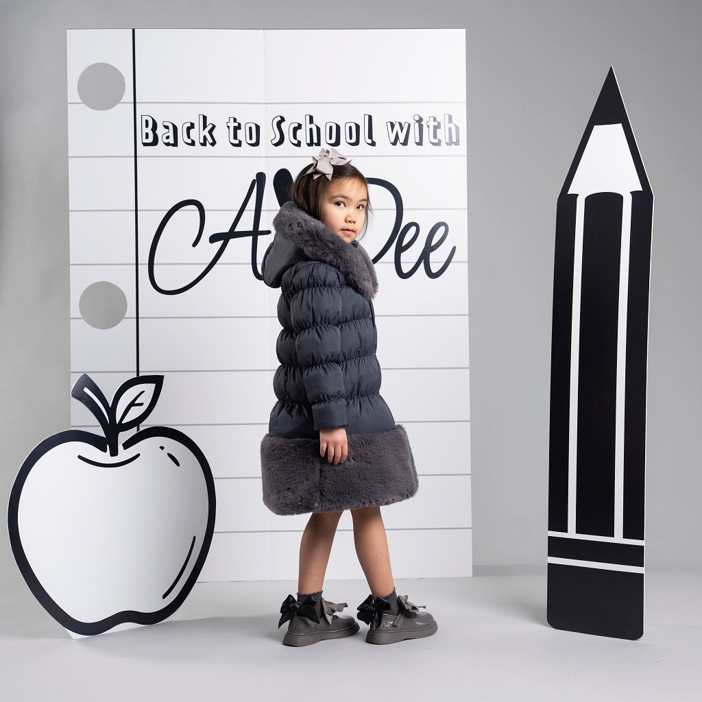 ADEE BTS The Rhea long length padded jacket features a luxurious fur trim around the hem and on the hood. Complete with a diamante badge on one sleeve and branded zip fastening. The perfect jacket to keep cosy going back to school. Dark Grey