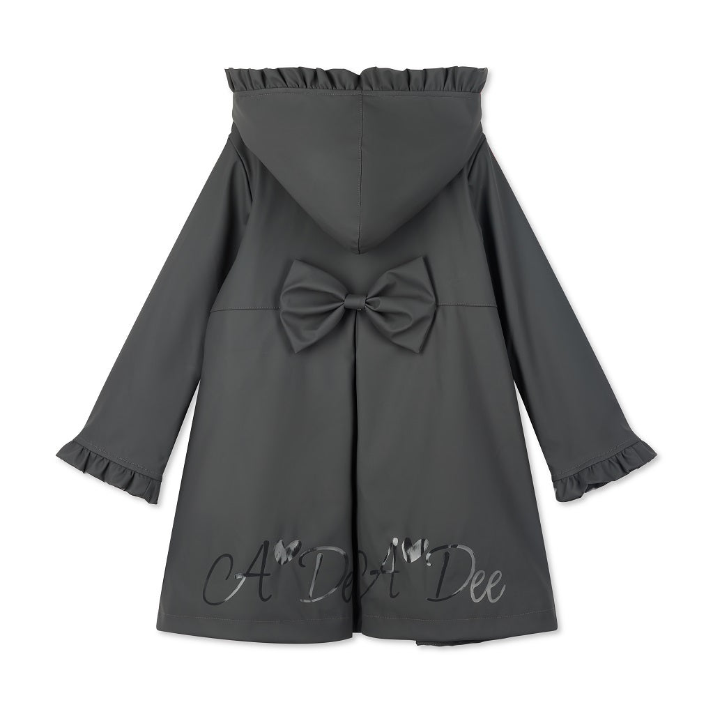 ADEE BTS The Nova is the must-have back to school raincoat! It features front and back pleats with pretty bow detailing, branding around the hem and frills at the cuffs and hood. Complete with a silver reflective logo badge on one arm and a silver branded puller. Dark Grey