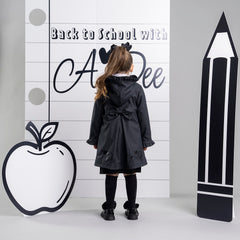 ADEE BTS The Nova is the must-have back to school raincoat! It features front and back pleats with pretty bow detailing, branding around the hem and frills at the cuffs and hood. Complete with a silver reflective logo badge on one arm and a silver branded puller. Black