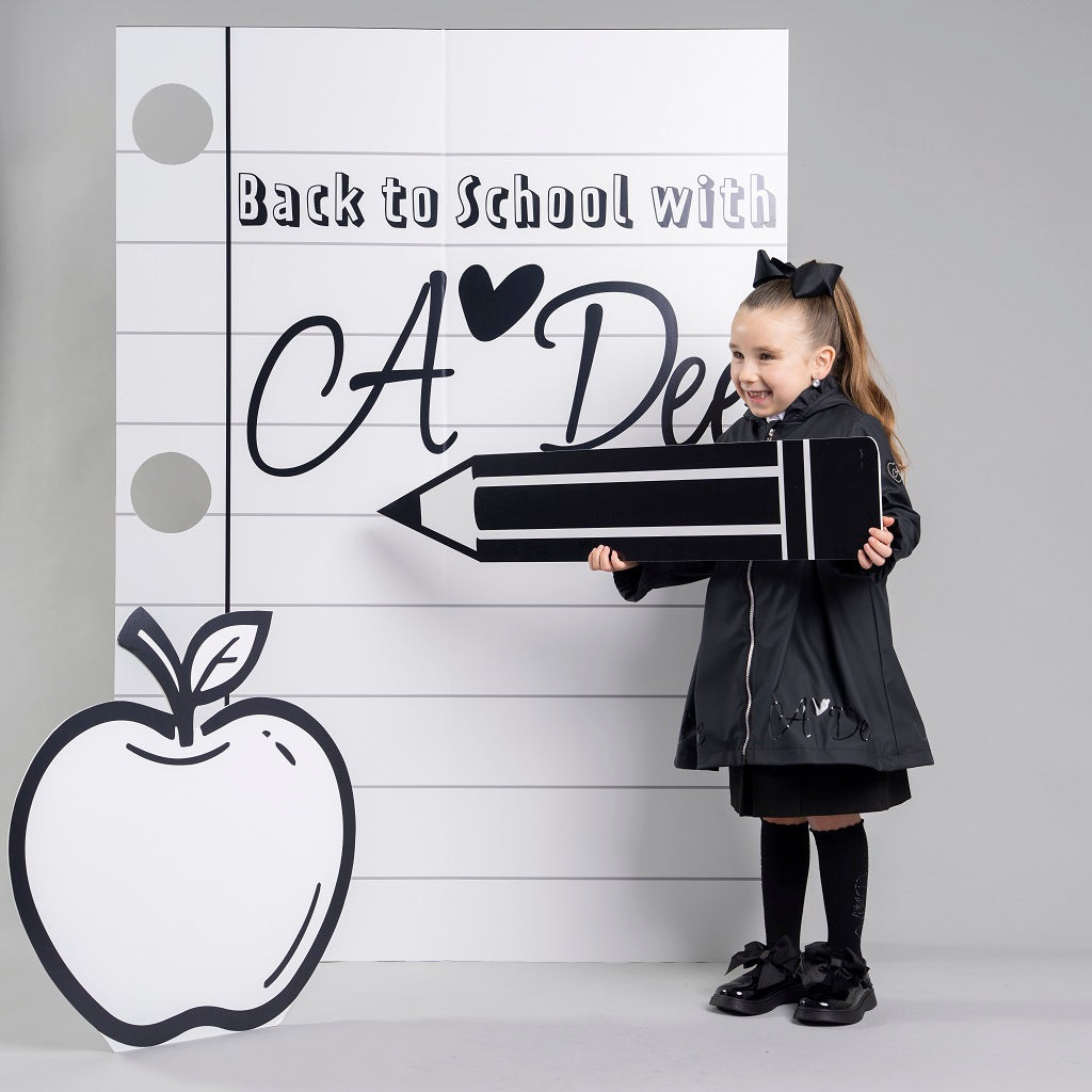 ADEE BTS The Nova is the must-have back to school raincoat! It features front and back pleats with pretty bow detailing, branding around the hem and frills at the cuffs and hood. Complete with a silver reflective logo badge on one arm and a silver branded puller. Black