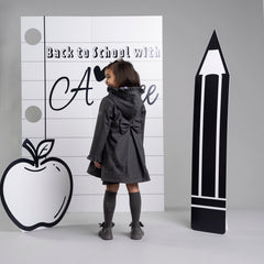 ADEE BTS The Nova is the must-have back to school raincoat! It features front and back pleats with pretty bow detailing, branding around the hem and frills at the cuffs and hood. Complete with a silver reflective logo badge on one arm and a silver branded puller. Dark Grey